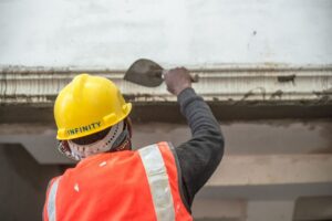 Safely puncturing a bulging ceiling drywall to relieve water pressure into a bucket